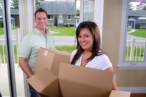 Professional movers handling furniture in a Brockley flat move
