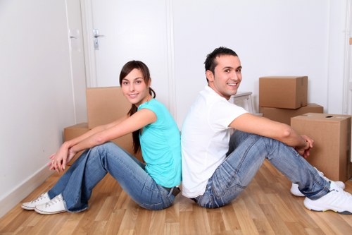 Packed boxes and moving equipment prepared for a Brockley relocation