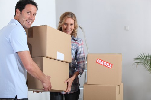 House movers unloading boxes and furniture at a Brockley property